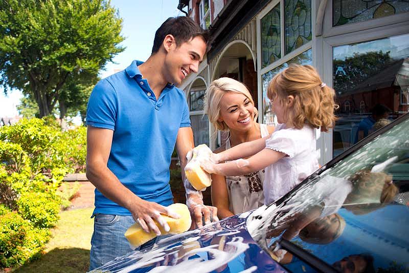 Family washing their car at home