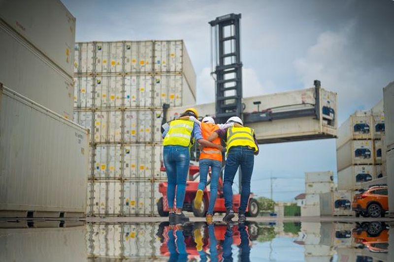 Workers helping co-worker with injured leg